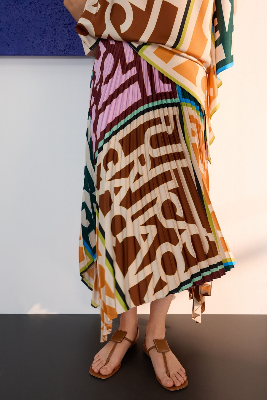 PG LINES PRINT TWILL ASYMMETRIC PLEATED SKIRT